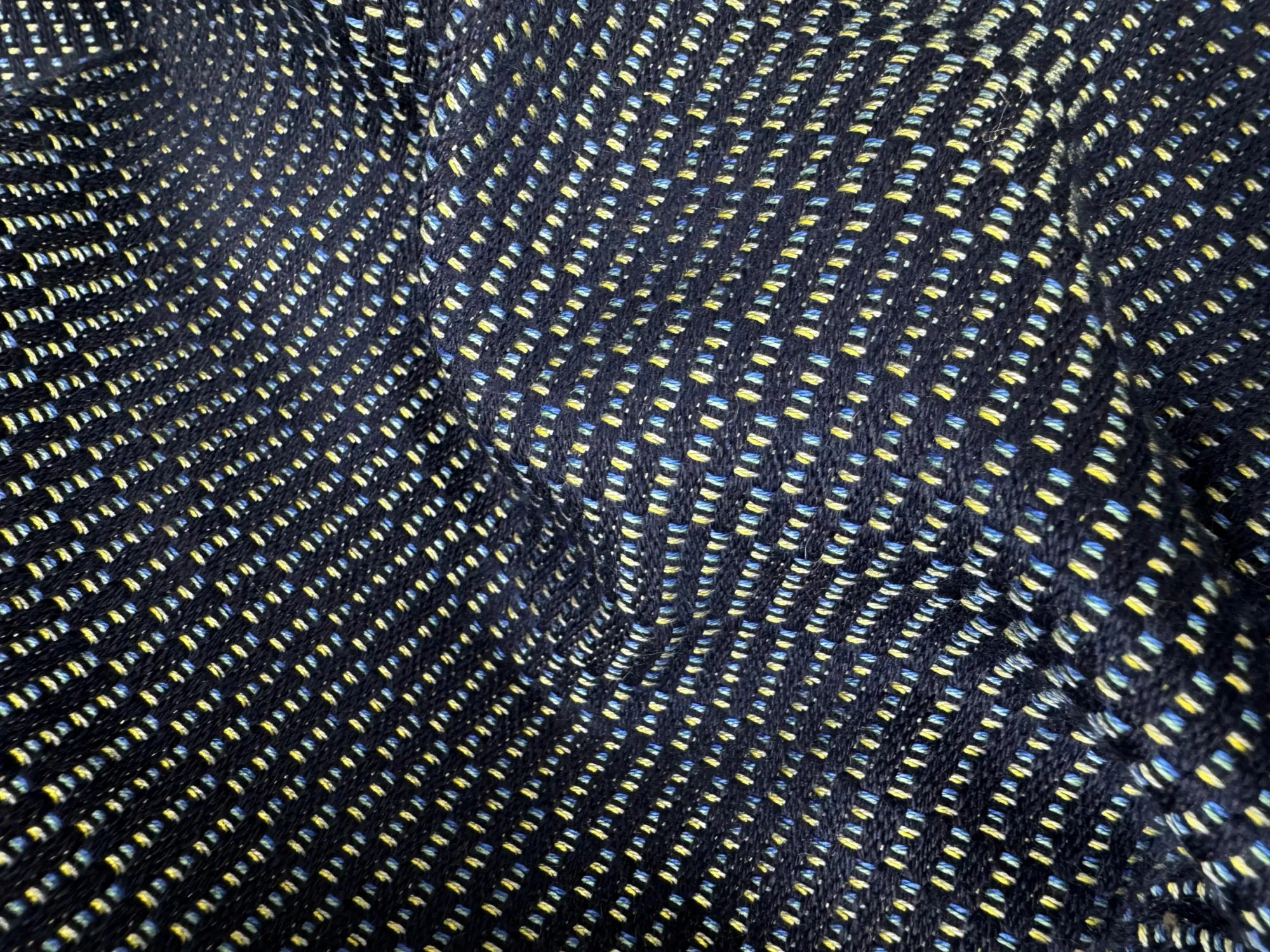 Close detail of Haus Nuller woven textile developed for the Catilina chair cushion.