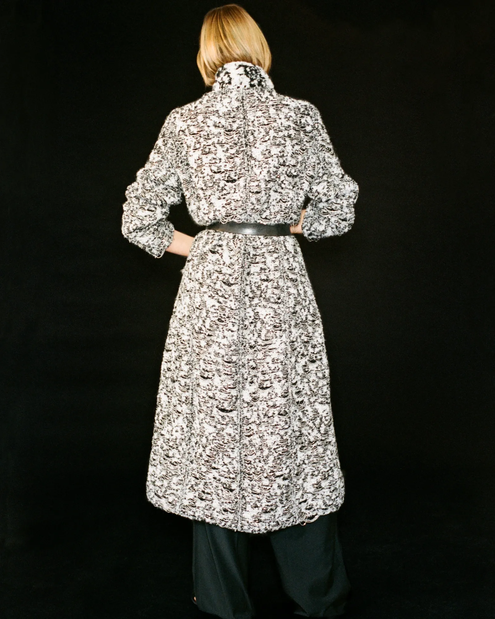 Close detail of Haus Nuller Collection N1 Coat 01 woven textile and chain structure.